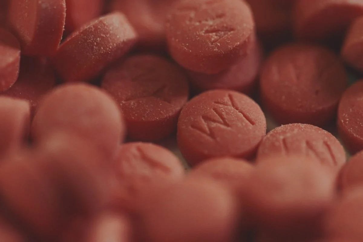 Macro photograph of red yaba tablets stamped WY
